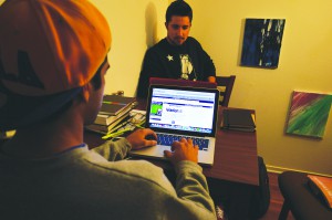 Photo by Scott Woodward -- Bachelor of applied theology students Matthew and Tyler Perry read the application requirements for on-campus leadership positions.